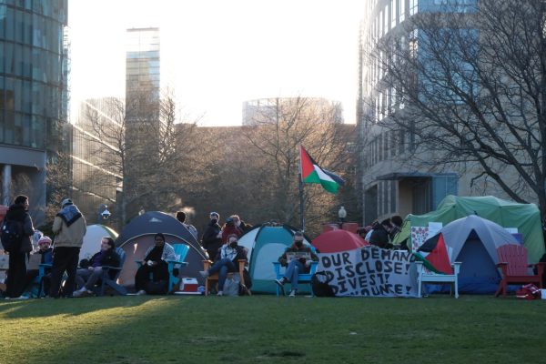 Protesters sit on the border of the Centennial Common encampment April 26. Some Black student protesters spoke about their mutual respect for the Palestinian people.