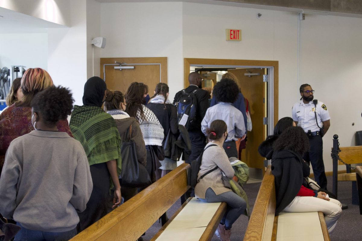 Students, family and supporters file out of a courtroom in the Boston Municipal Court in Roxbury before students’ arraignments. Some students reported that essential items like medications and electronic devices were in NUPD custody, and feared that retrieving their belongings would further aid the university in punishing them.