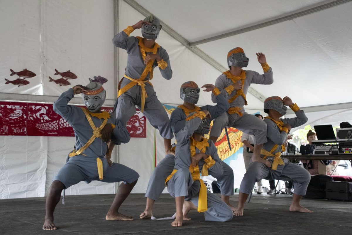 Members of the Angkor Dance Troupe perform a Cambodian monkey dance. Dancers impressed the audience with backflips, backspins and cartwheels.
