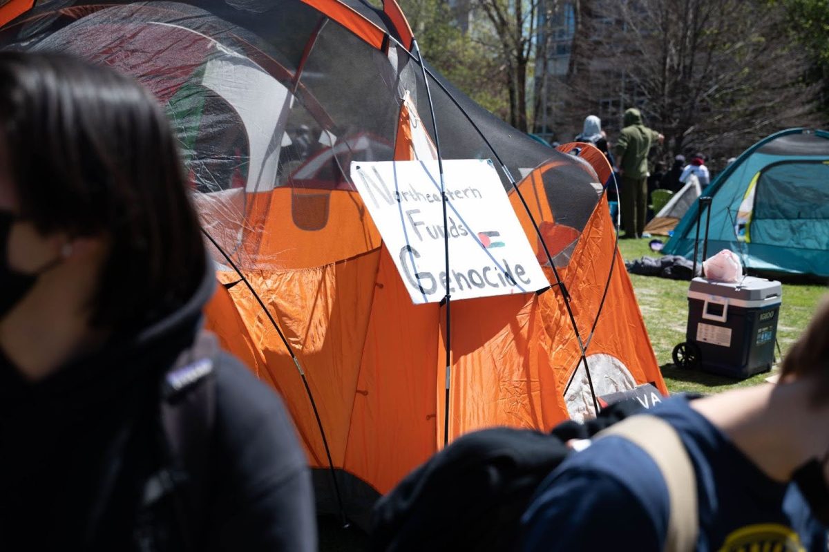 A sign on an encampment tent reads, Northeastern Funds Genocide. Protesters demanded that the university disclose its financial investments, divest from organizations that do business with Israel and denounce what they called Israels ongoing genocide in Gaza.