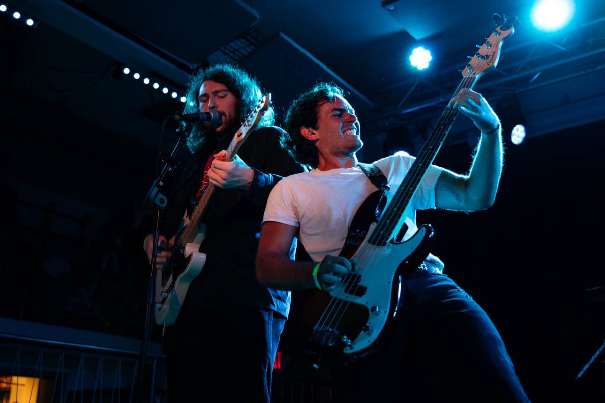 Lead singer Peter Tuohy and bassist Tom Dalton of Reservations at 8 lean into each other while performing at a concert at Sonia July 20. Read more here.