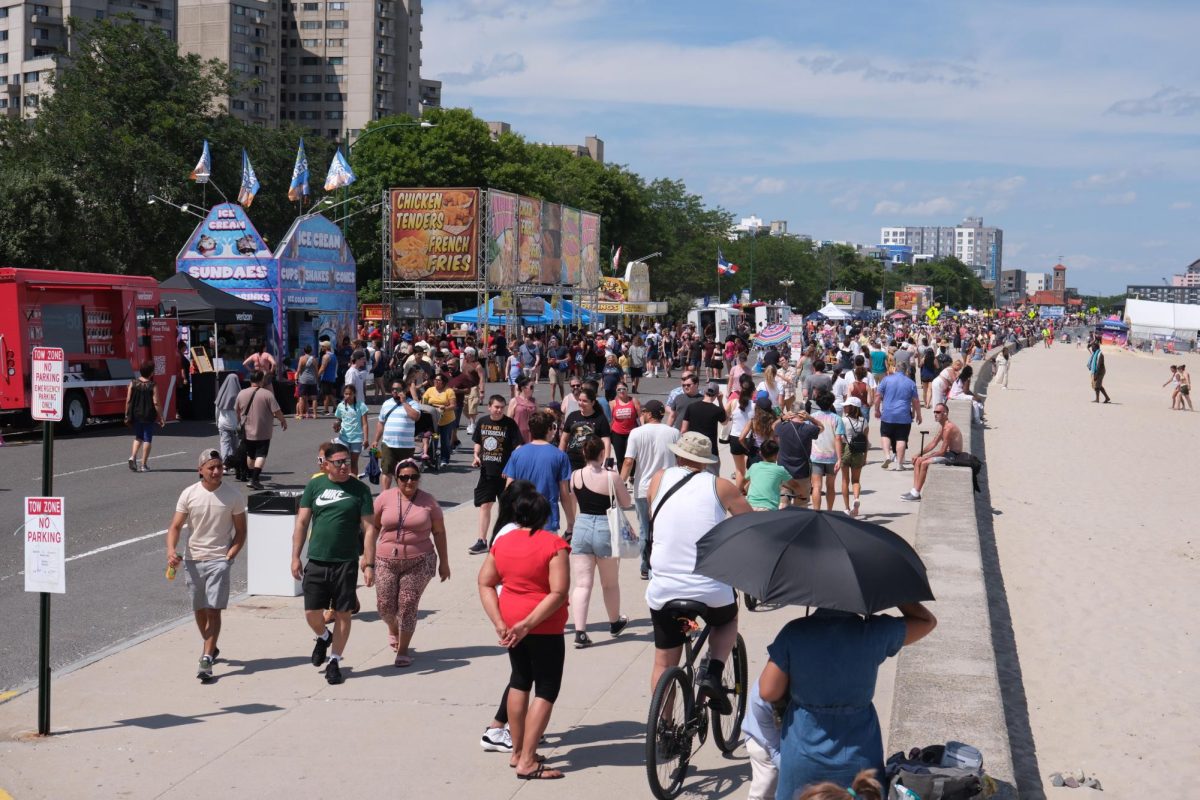 Crowds roam Revere Beach Boulevard. Vendors sold lunch from food trucks and served cold refreshments from ice cream stands and a beer garden.