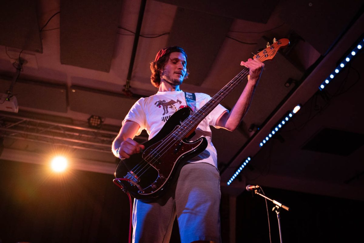 Matt Fitzgerald closes his eyes as he plays the bass guitar for Off Wing. Members of both American Ink and Reservations at 8 stayed to watch Off Wing’s set.