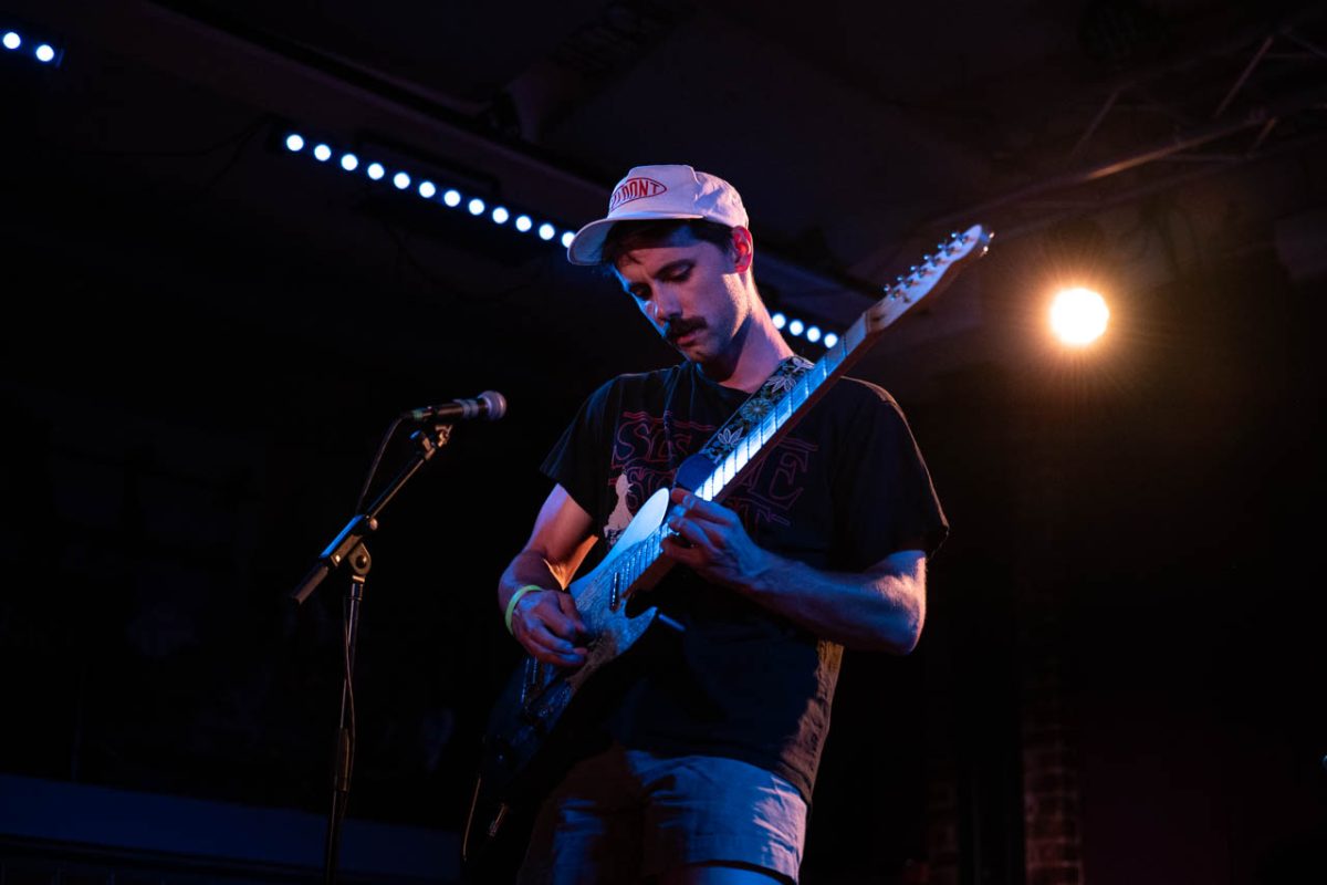 Matthew Geyer, a guitarist for Off Wing, plays his guitar while the set lights shine behind him. The entire show lasted around two hours. 