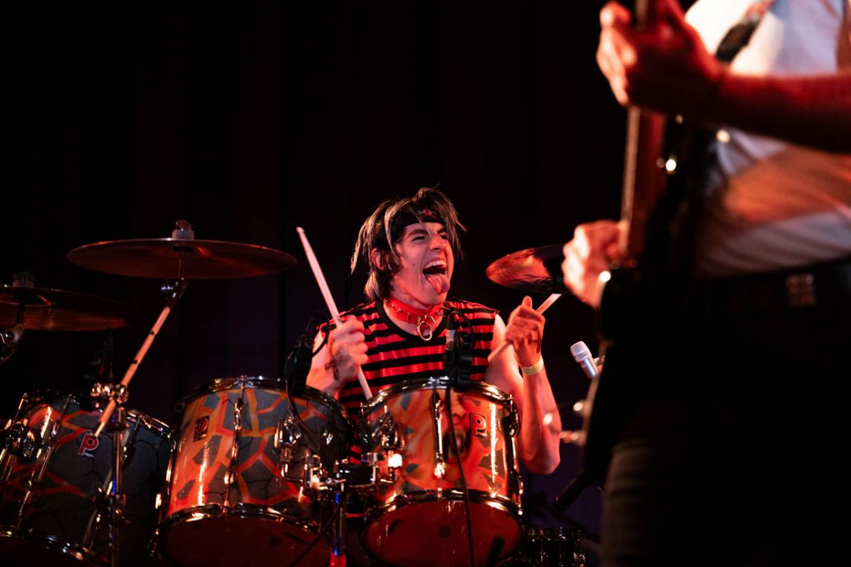 Duffy sticks his tongue out while playing the drums. He maintained an engaging stage presence and later emphasized how important it was to the band to match the music with its visual performance. “Audiences listen with their eyes,” Duffy said.  