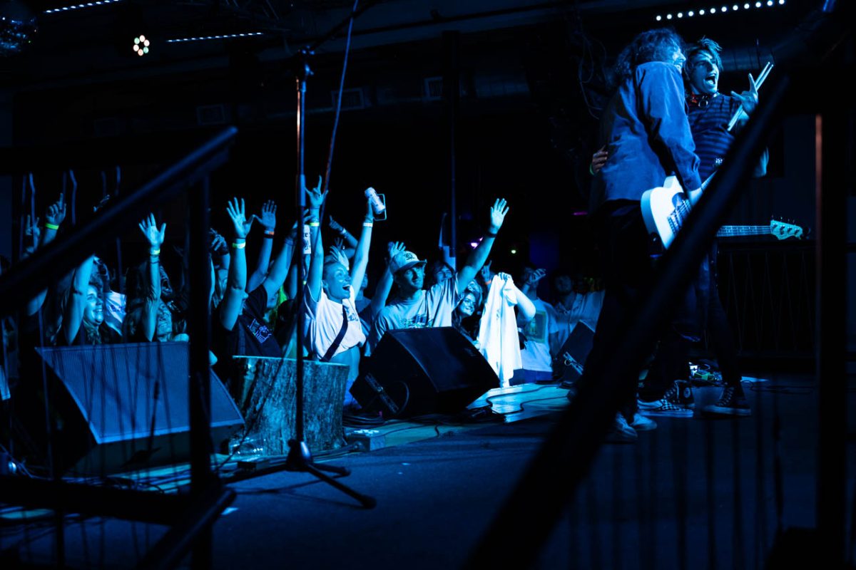 The audience raises their hands as Reservations at 8 takes a photo with the crowd. The audience’s support was constant throughout the entire concert, with people cheering, moshing and dancing. 