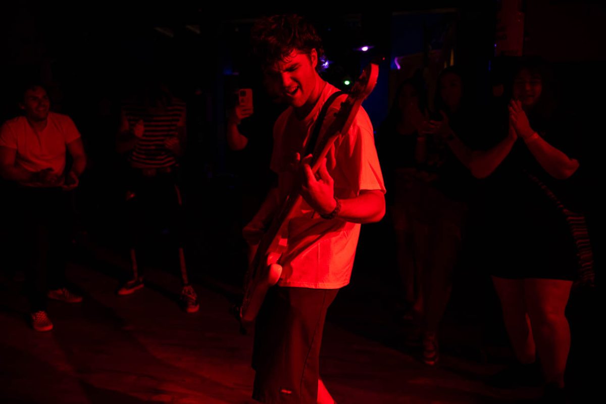 Crotty plays his bass guitar in the crowd. People circled around him and cheered him on, even starting to mosh. 