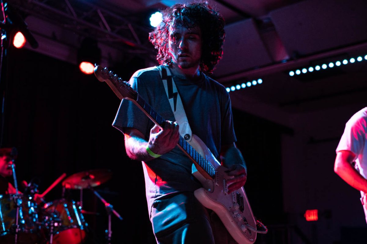 Romano plays the guitar while moving around the stage. He was one of the most mobile performers of the night. 