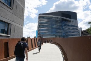 Students walk toward EXP on the Interdisciplinary Science and Engineering Complex Pedestrian Bridge. The total cost of attendance for Northeastern undergraduates during the 2023-24 academic year was $86,000.