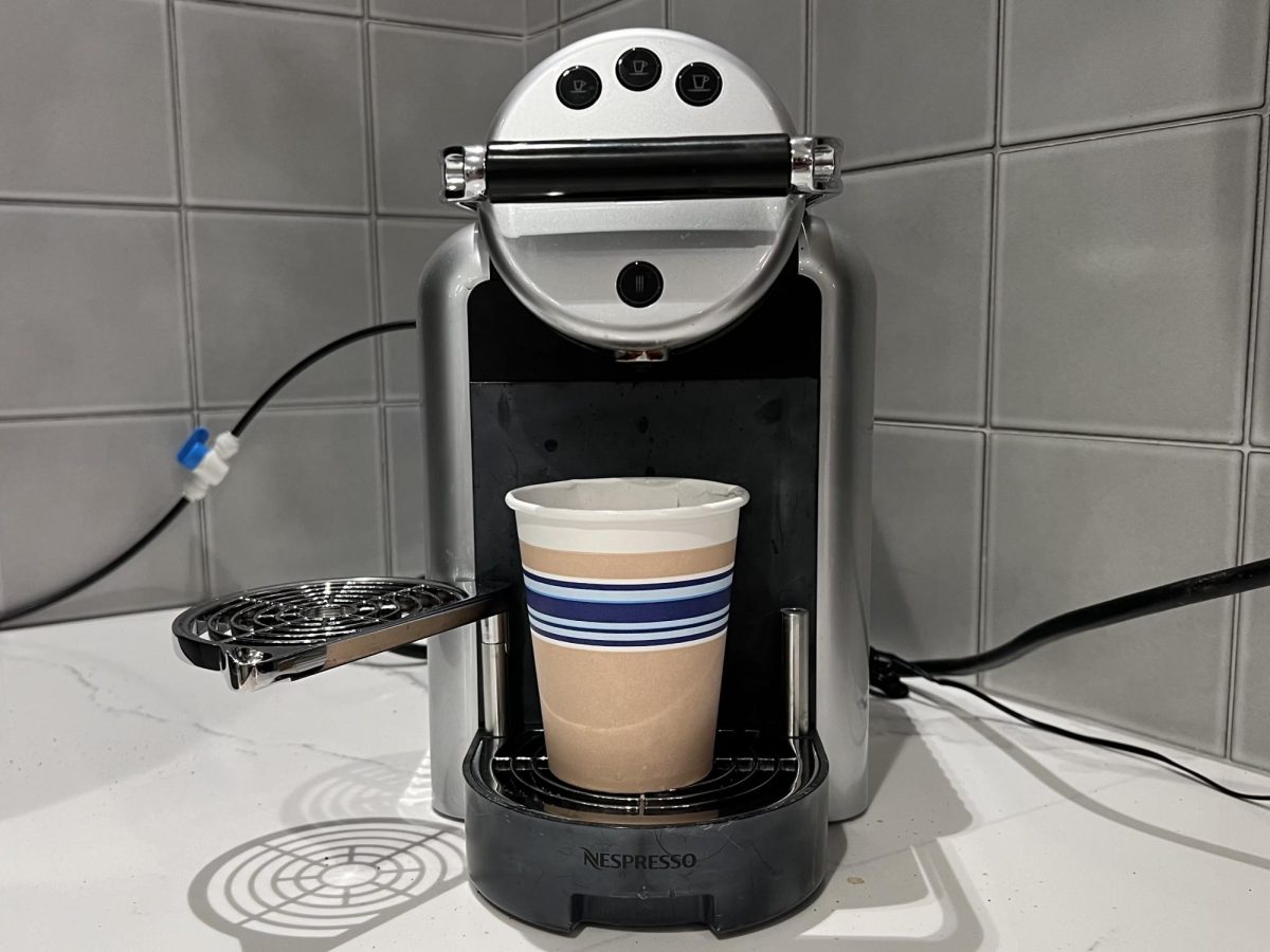 A coffee cup sits under a Nespresso machine. A survey of more than 1,300 Americans found that 36% of people drank three to five cups of coffee a day.