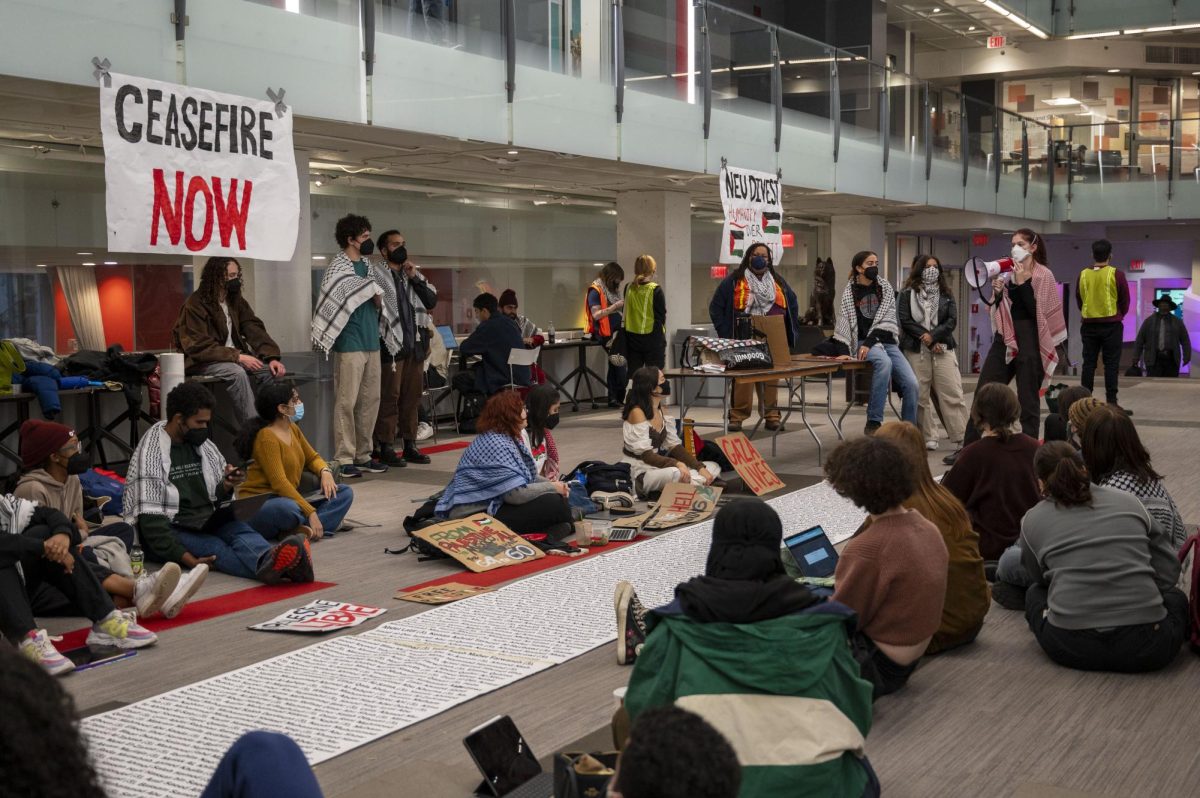 Student protesters listen to and participate in chants during a Dec. 1 pro-Palestine sit-in that resulted in three students being placed on deferred suspension. The complaint against Northeastern included six steps for the university to take to redress the alleged impacts on affected students.