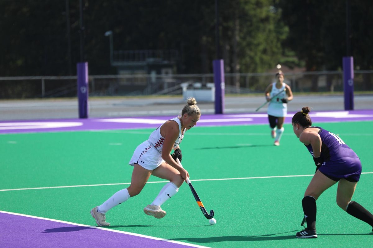 Graduate midfielder Mak Graves maintains possession of the ball against Holy Cross Sept. 15. The Huskies tallied 15 shots in the game, including nine shots on goal. Photo courtesy Lucas Wessel.