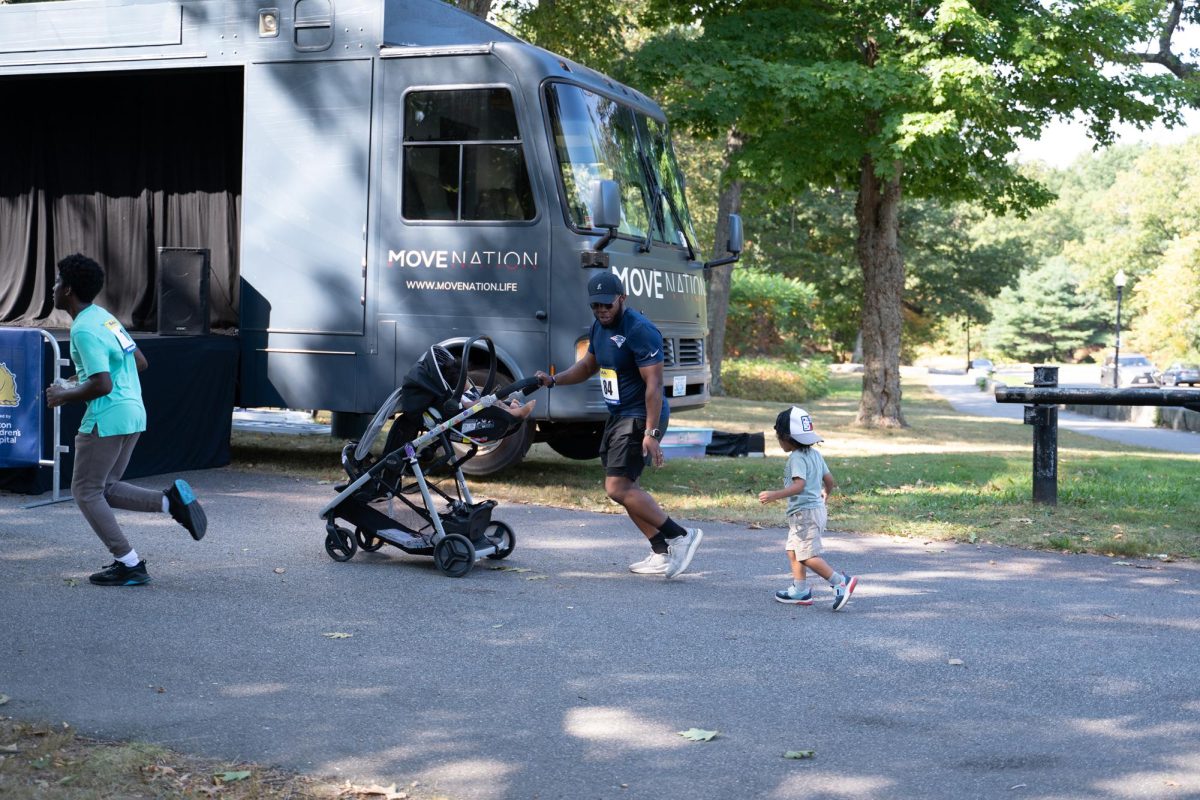 A man runs with a stroller and his child.