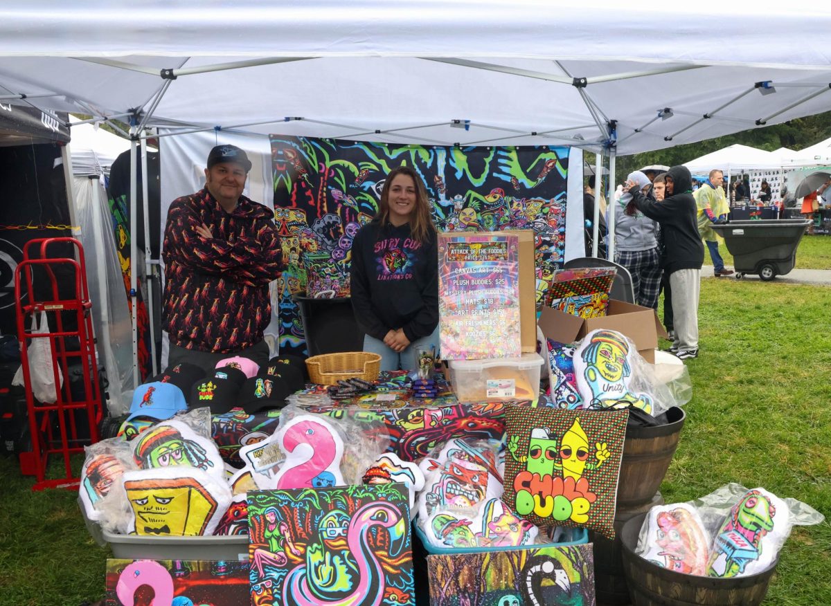 Two vendors from Attack of the Foodies pose for a photo with their products. The Boston Freedom Rally featured a variety of local vendors.