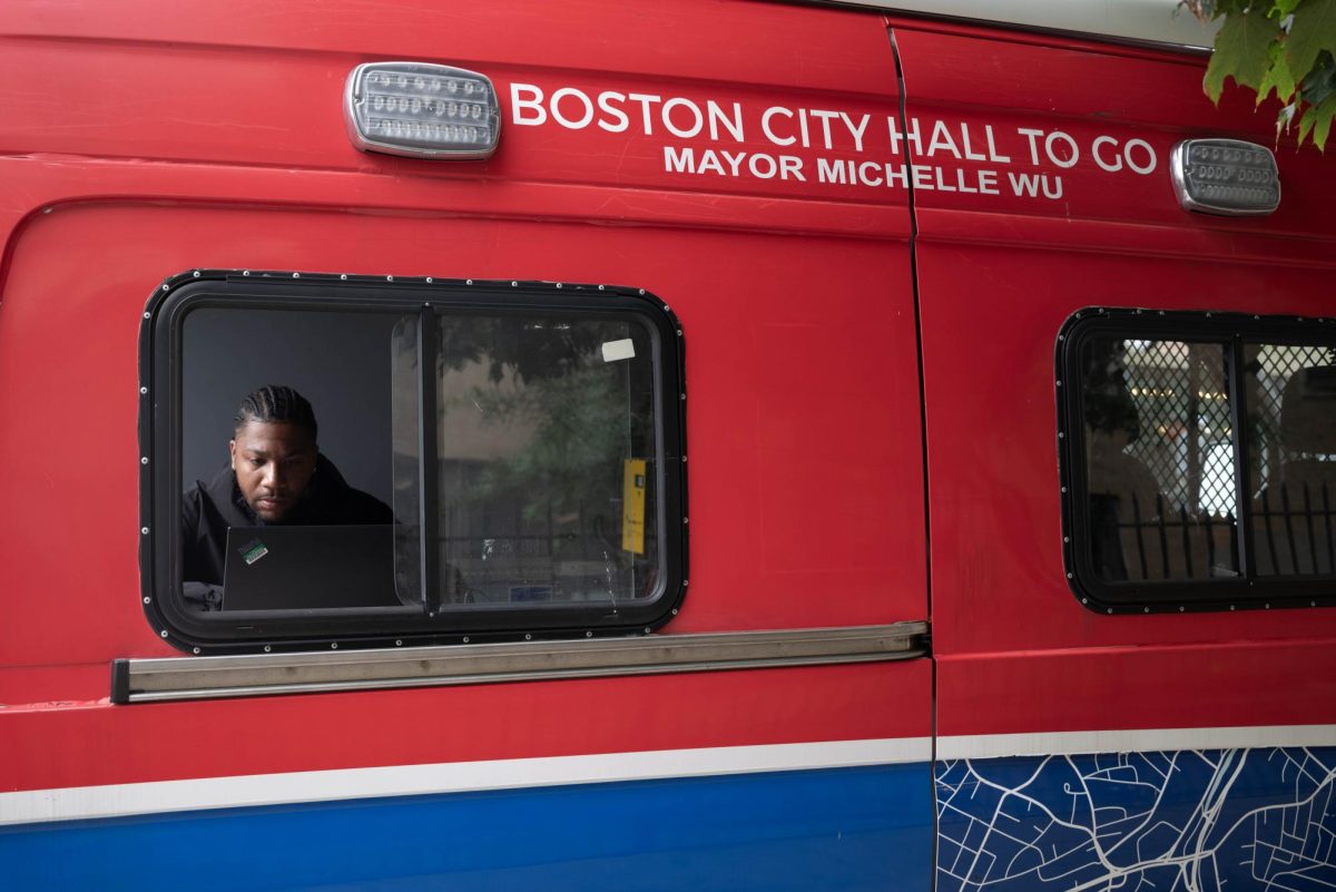 Errol Johnson sits in the City Hall on the Go truck, ready to assist Boston residents. The truck has offered services such as absentee ballot requests, parking ticket appeals, health insurance applications and marriage certificate requests.