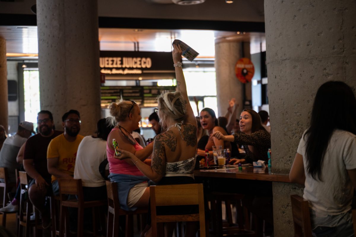 A bingo player holds up their bingo card. Some attendees were frequent participants in Time Out Market's events.