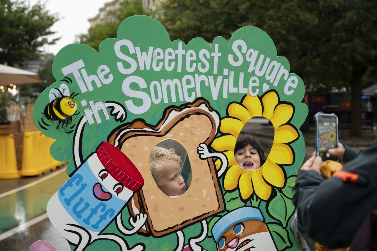 Two children pose in a photo stand-in. Multiple colorful, illustrative photo stand-ins were placed along Somerville Avenue.