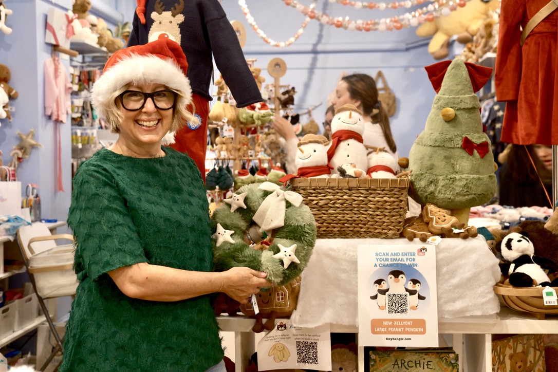 Berman poses with her Jellycat of choice — “Nordic Spruce Wreath.” Berman opened Tiny Hanger in 2011 and has offered children’s apparel to the Brookline community since.