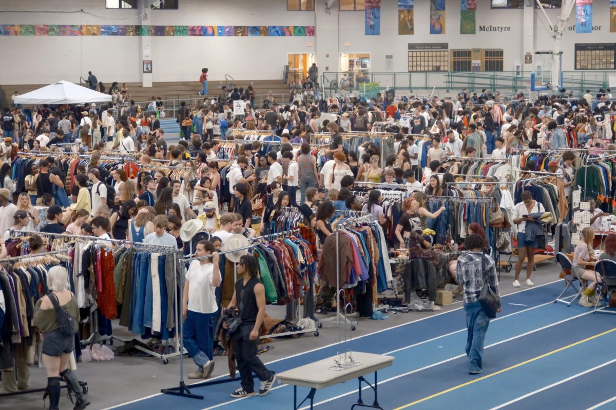 Customers peruse and purchase clothing from the annual MASSive Thrift Market at the Reggie Lewis Track and Athletic Center. Thrifting organizations such as Select Markets and Thrift2Death hosted the event for the first time.