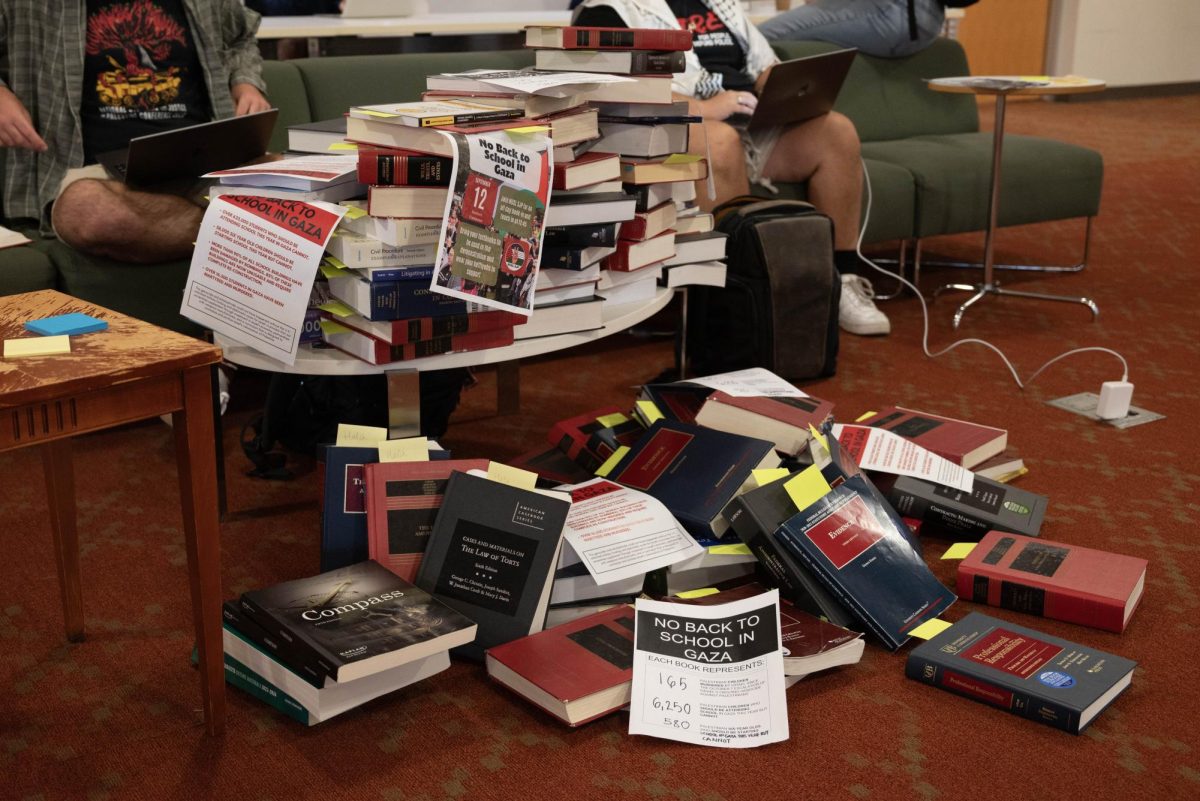 A pile of textbooks sit in the middle of Dockser Commons. The books were left as part of a "book-in" demonstration by NUSLSJP to protest the ongoing “scholasticide” and “genocide” in Gaza.