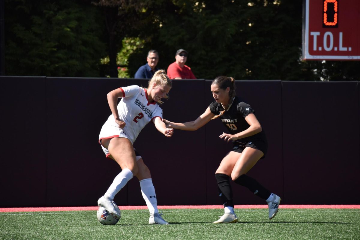 Jessie Hunt fights for possession against a Bryant defender Sunday. The Huskies tallied three shots on goal in the scoreless draw.