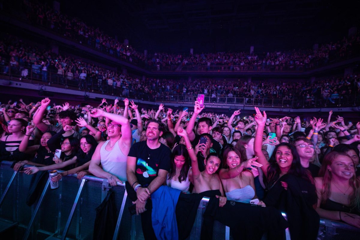 Fans scream in excitement and raise their hands up in the air. Zedd had just walked onto the stage, ready to start his set.