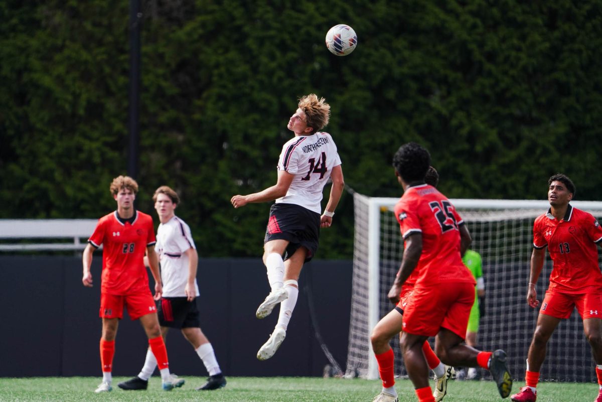 Northeastern’s sophomore defender Thomas Vold jumps for the header against Campbell Saturday. The Huskies tallied only nine shots in the shutout loss. 