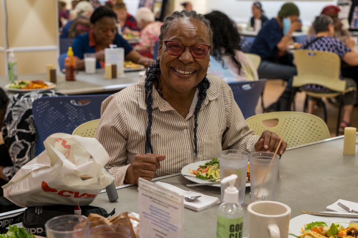 A guest at WLP smiles as she sits to eat. Alongside daily necessities like meals and showers, WLP also started investing in mental health services. Photo courtesy Nancy Schieffelin, WLP.