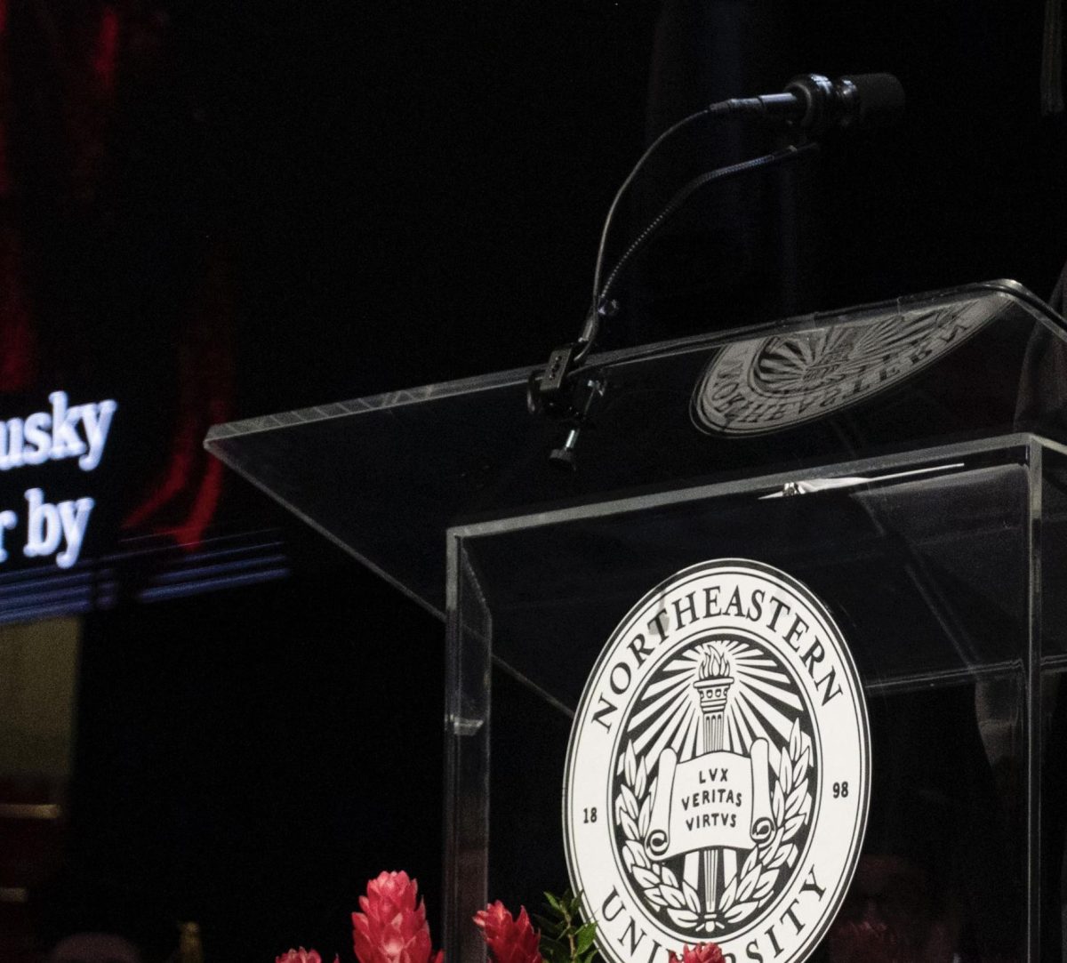 A podium at the 2024 convocation ceremony features a Northeastern logo. Northeastern faculty discussed the university's new freedom of speech and expression policies at the Oct. 16 faculty senate meeting.