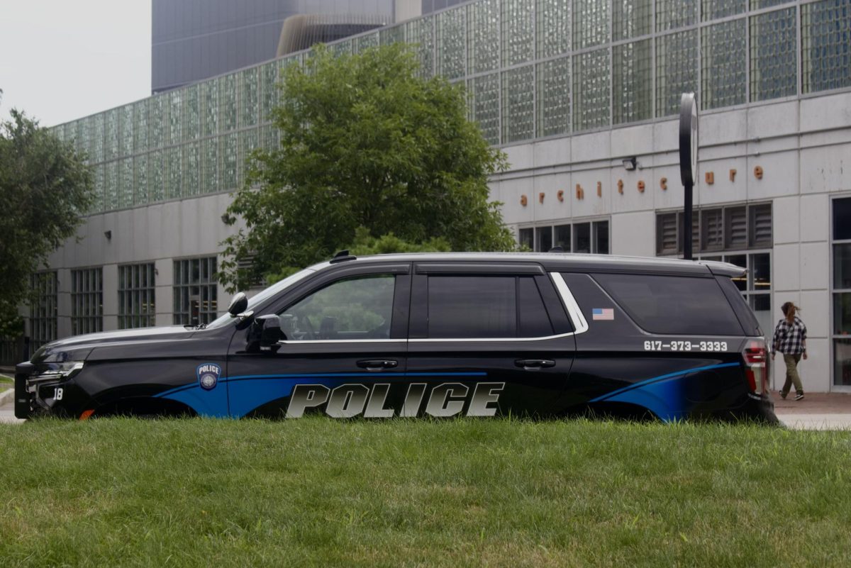 An NUPD officer sits in a car outside the Ruggles T stop. Northeastern recently released its 2024 ASR, revealing crime statistics for all Northeastern campuses.