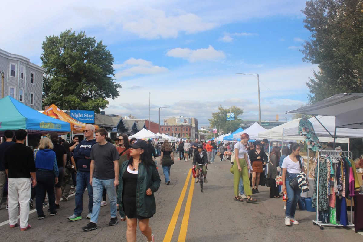 Attendees flow in and out of booths on Harvard Avenue. The festival ran from noon to 6 p.m., with crowds growing as the day went on.