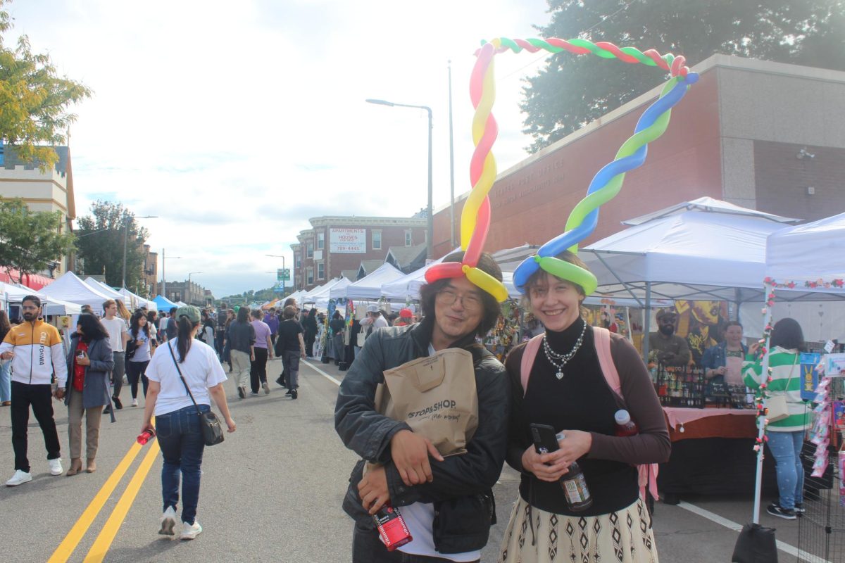 Festival attendees pose with their balloon hat. The kids’ section featured a balloon artist making animals.