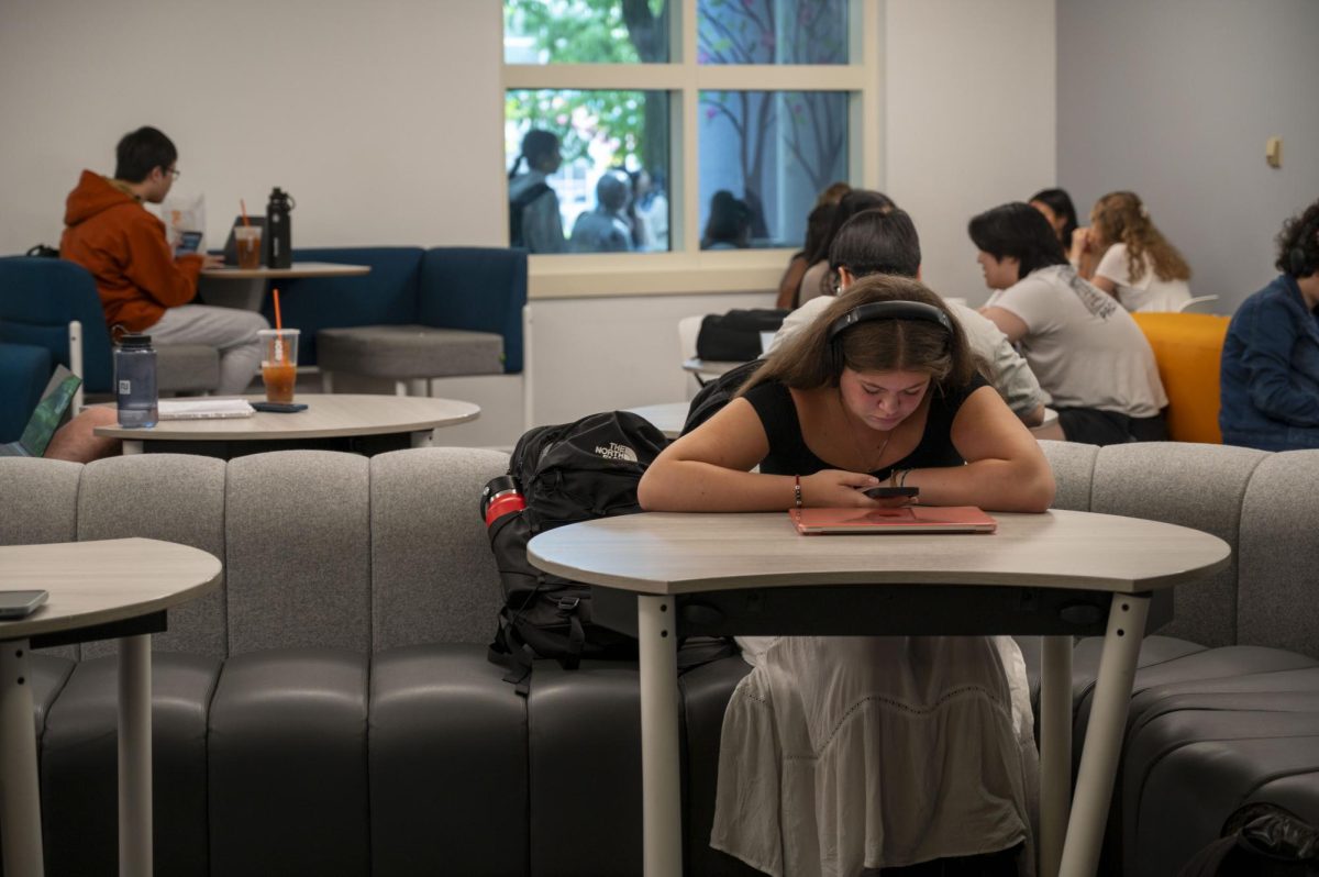 A student in Shillman Hall looks at her phone. The rise of instantaneous entertainment on social media platforms reduced children’s attention spans.