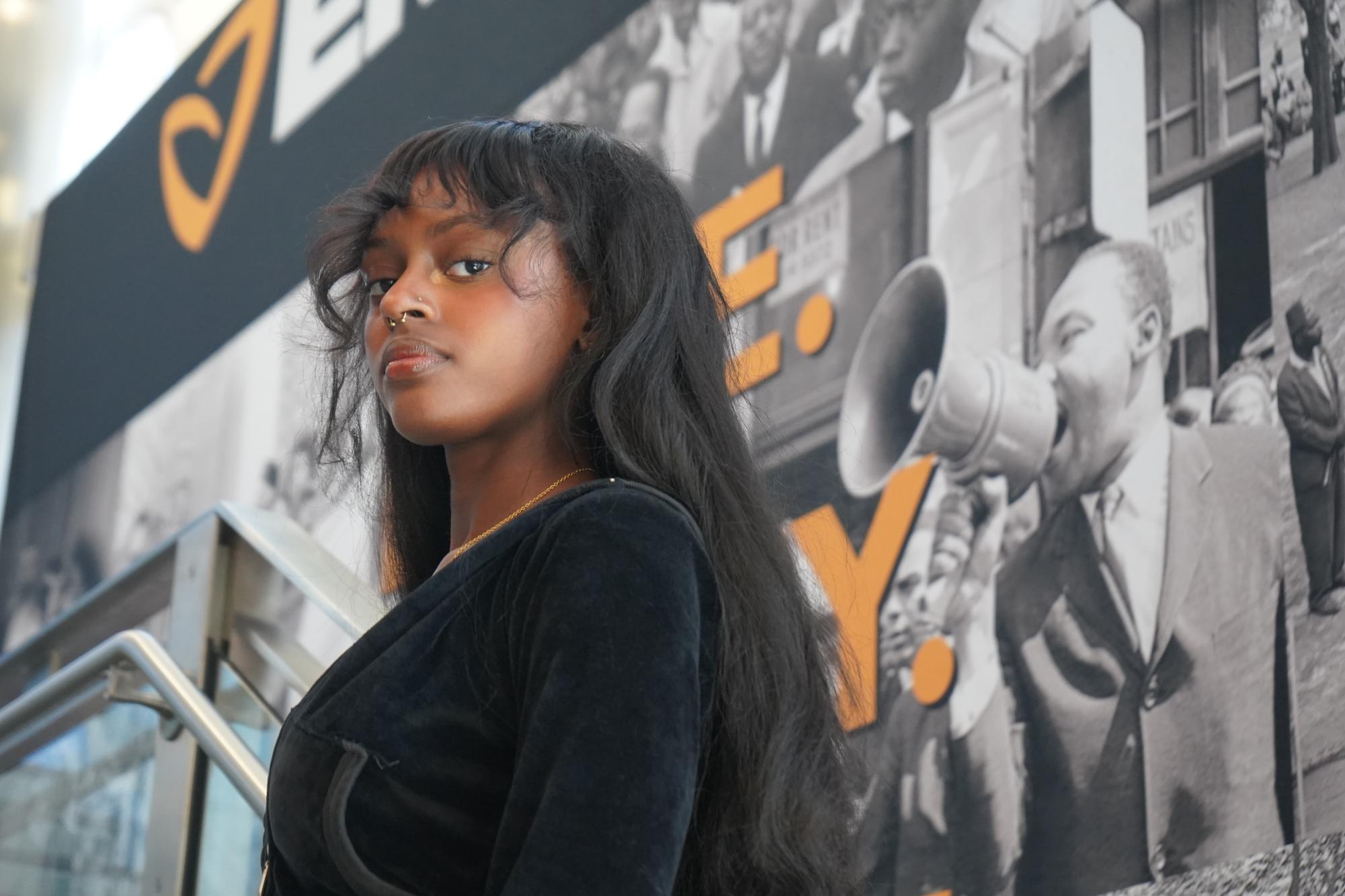 Courtney Cade stands on the steps of the John D. O'Bryant African American Institute. Cade shared how she believes diversity benefits whole communities.