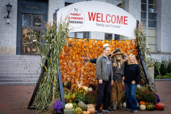 Two parents pose for a photo with an actor dressed as a scarecrow during last year's Family & Friends Weekend. The News' lifestyle editors curated a list of the top 9 places around Boston to bring loved ones during this weekend.