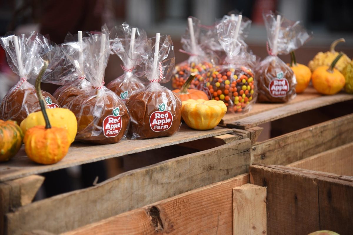 Red Apple Farm’s candied and caramel apples adorn a crate display. Red Apple Farm also offered bottles of apple cider and apple cider donuts.