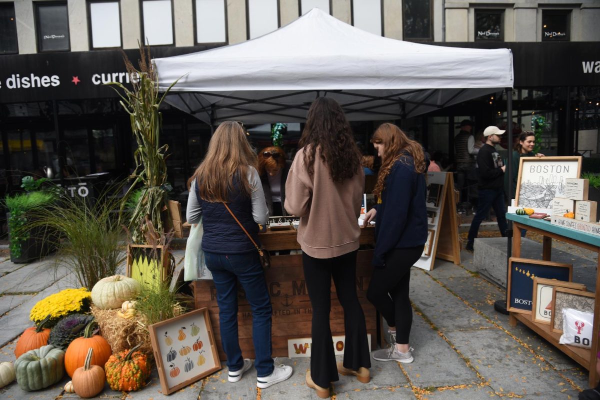 Passersby stop to take a look at Rustic Marlin’s Fall Fest. Rustic Marlin sold handmade wooden decor and even passed out free wooden Halloween decor.