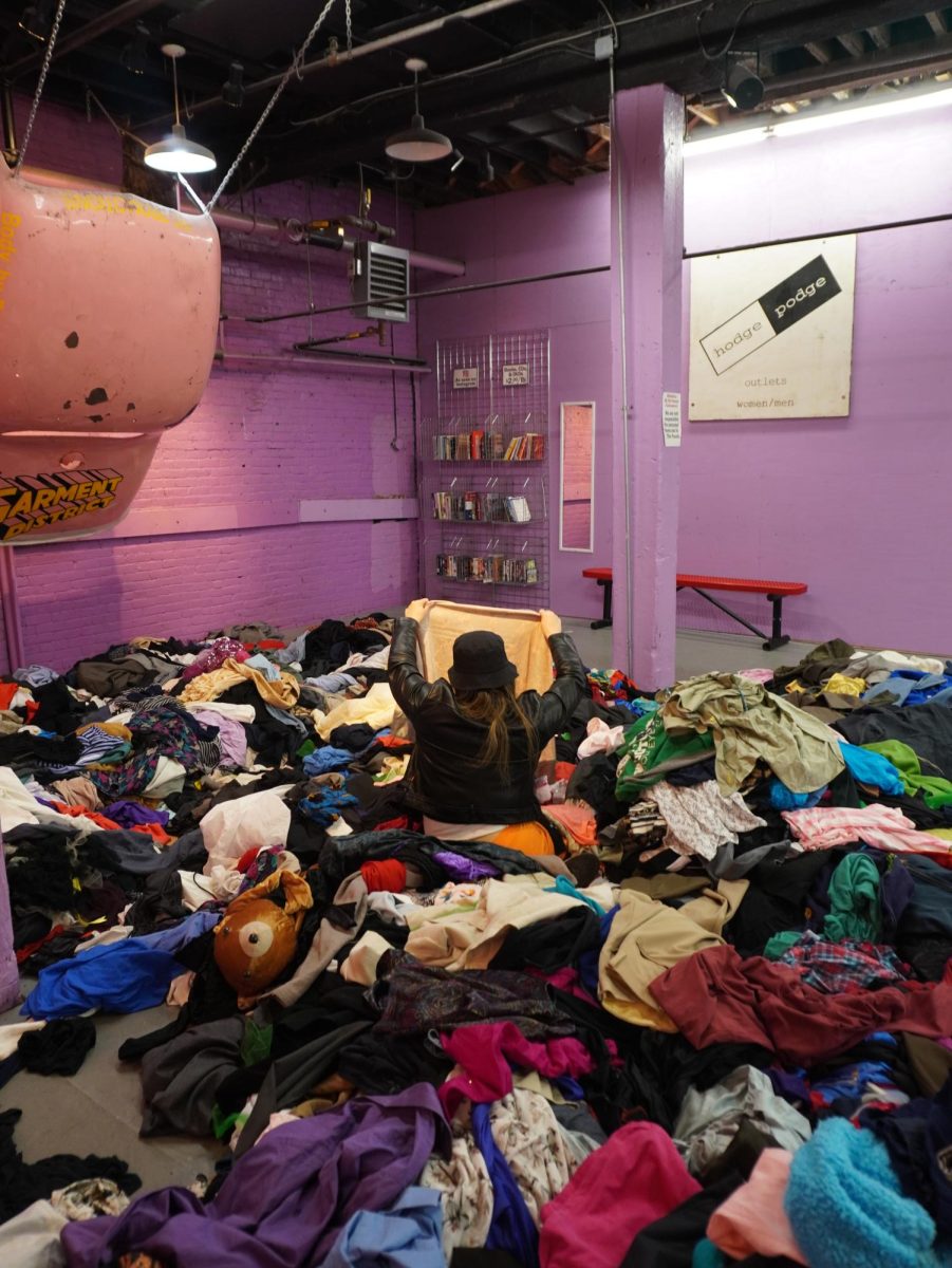 A customer rummages through clothes in the “By The Pound” section. The activity was made to be a staple of the store’s philosophy of sustainable consumption in fashion.