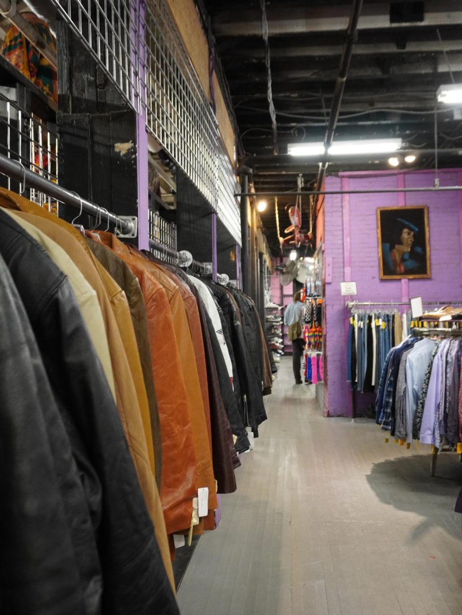 Leather jackets hang in a row, sorted by size. The clothes were displayed on a seasonal cycle. 