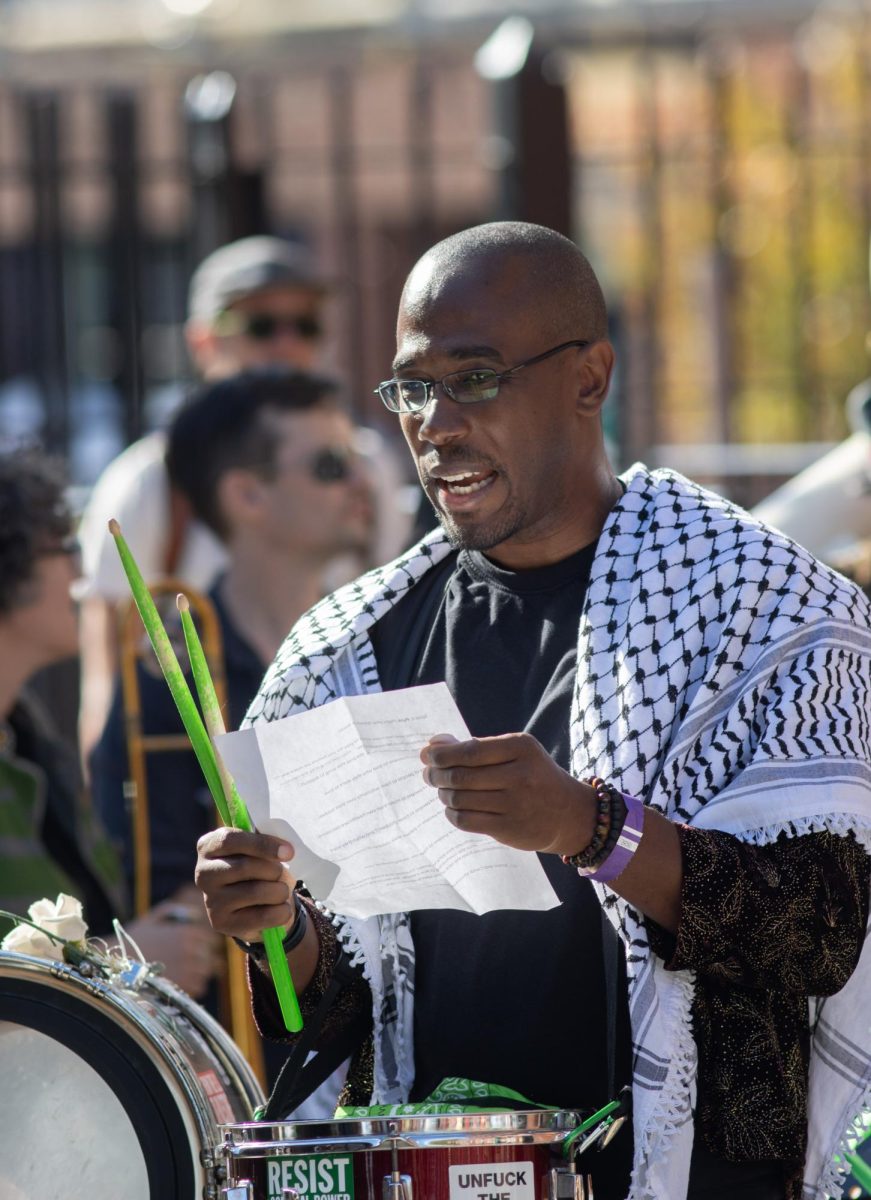 A drummer with New Orleans Musicians 4 Palestine reads from a lyric sheet as the band plays. Many bands advocated openly for progressive causes.