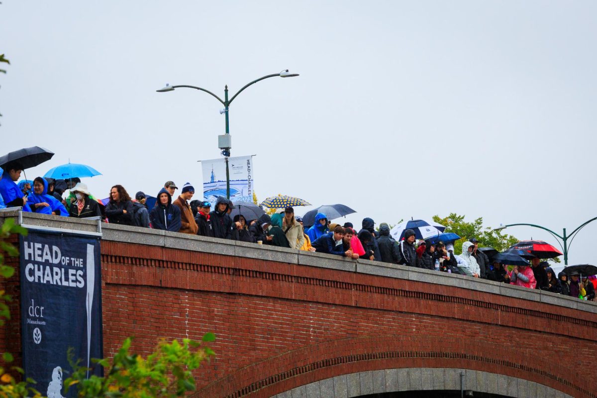 Despite the rain, people gather to watch rowers compete at the 2023 Head of the Charles Regatta. More than 200,000 spectators attended the event last year.