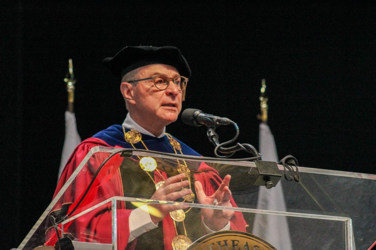 Joseph E. Aoun stands behind a podium at the 2022 President’s Convocation. Aoun only made one statement about the Israel-Hamas war one year ago. File photo by Marta Hill.