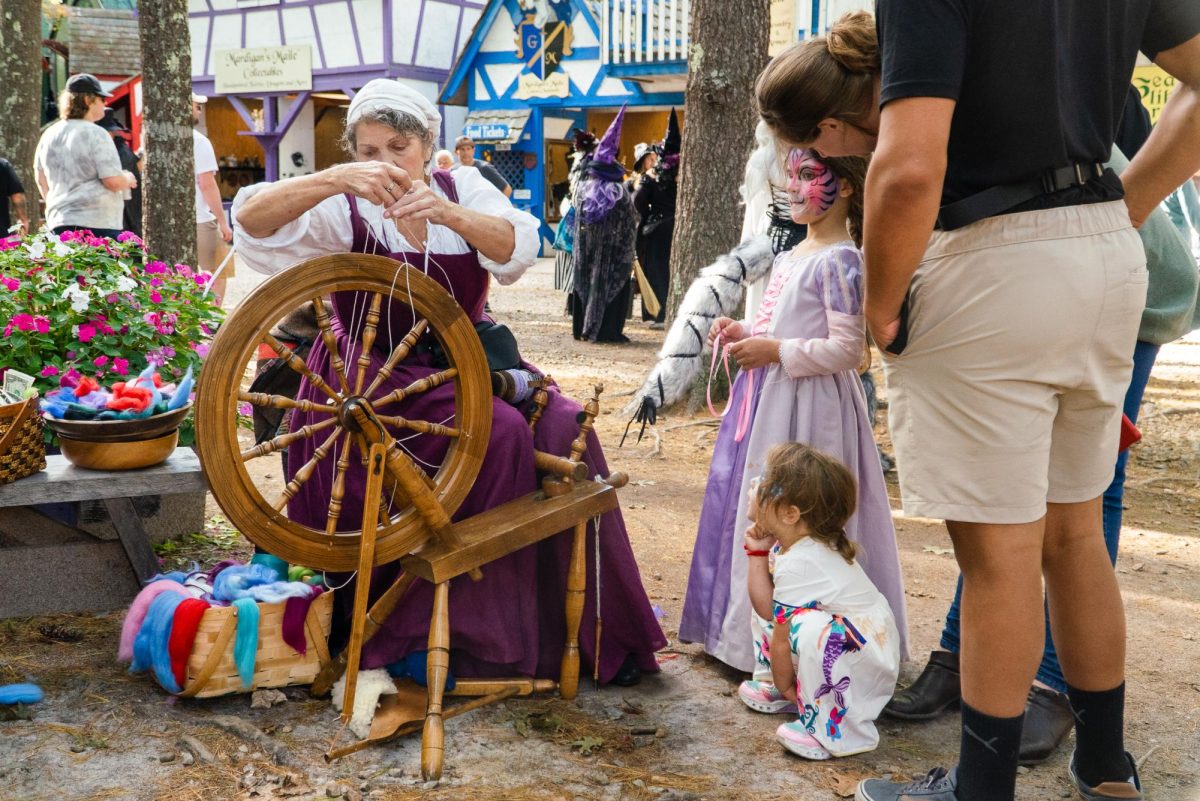 An artisan demonstrates fabric spinning. Many of the items sold at the fair were handmade.