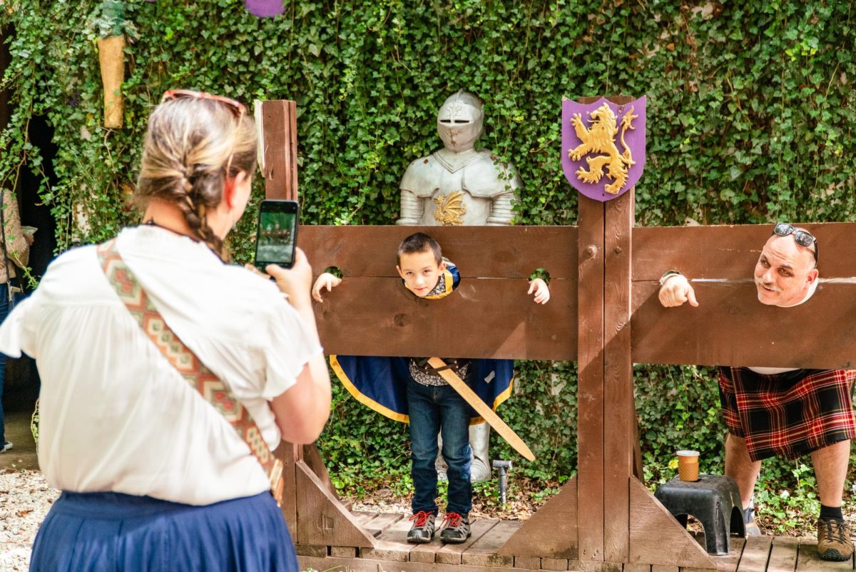 A family takes pictures in the stocks outside the “Dragonwick Dungeon” show. The exhibit
showcased a variety of medieval torture devices.