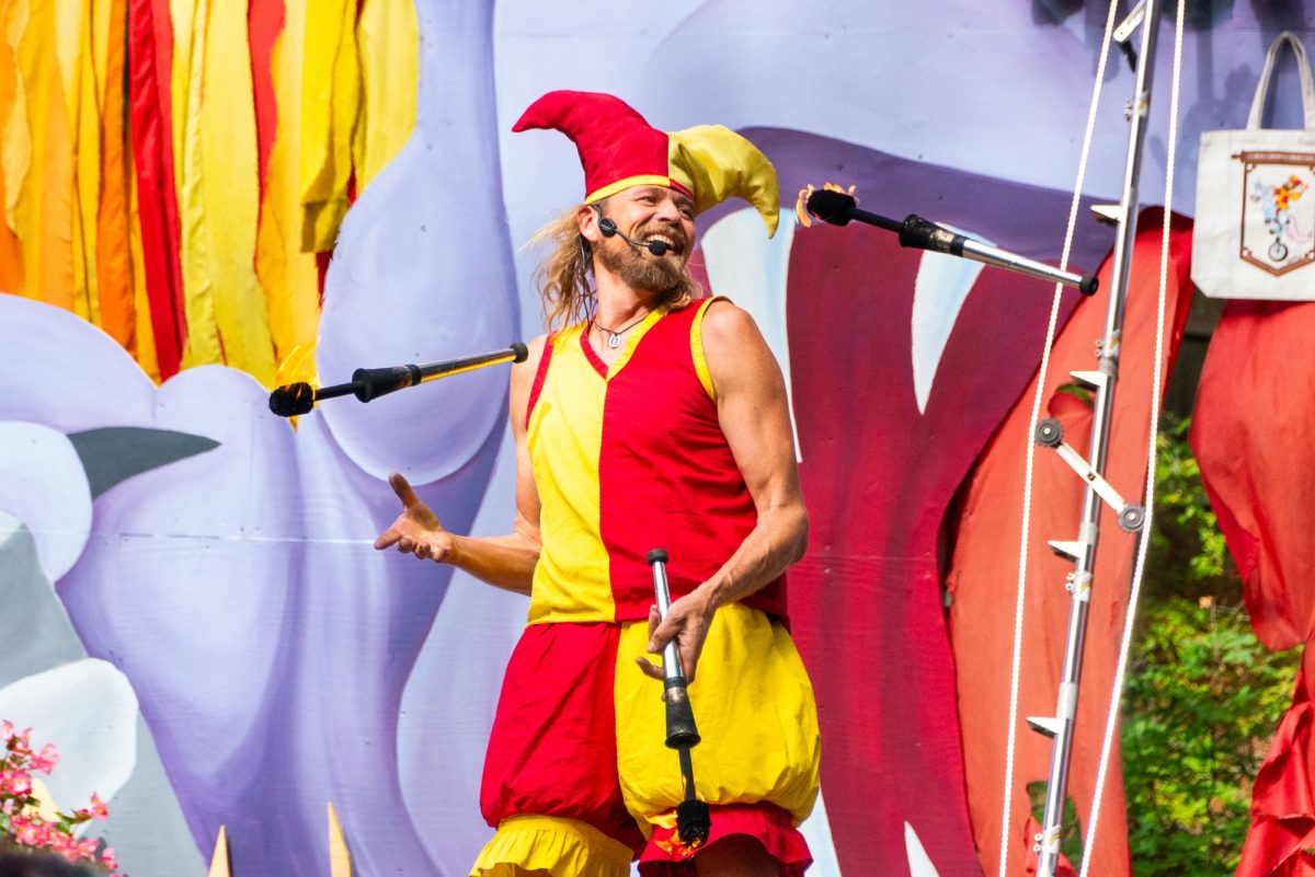 A performer demonstrates his skill by juggling three flaming torches. The “Wonder Show” was an act of psychic comedy and magic. 