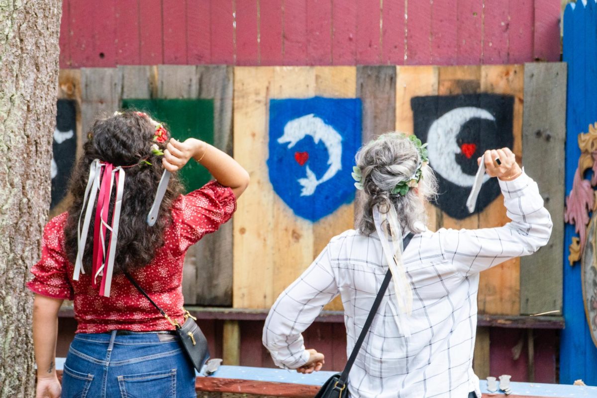  A mother and daughter participate in knife throwing. Interactive activities included crossbow shooting, axe throwing, darts and archery, which were spread across 80 acres of fairground.