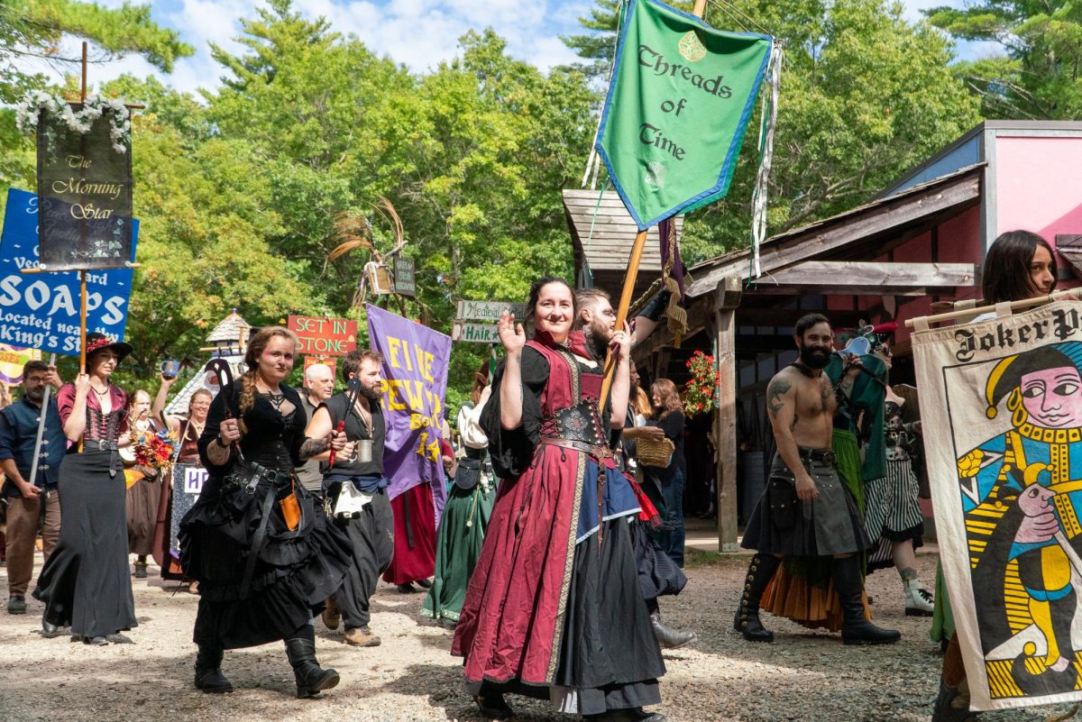 Actors, performers and vendors congregate around 12:45 p.m. to parade through the fairgrounds, playing music and displaying tricks. During the parade, they called out to other performers and vendors and interacted with attendees.