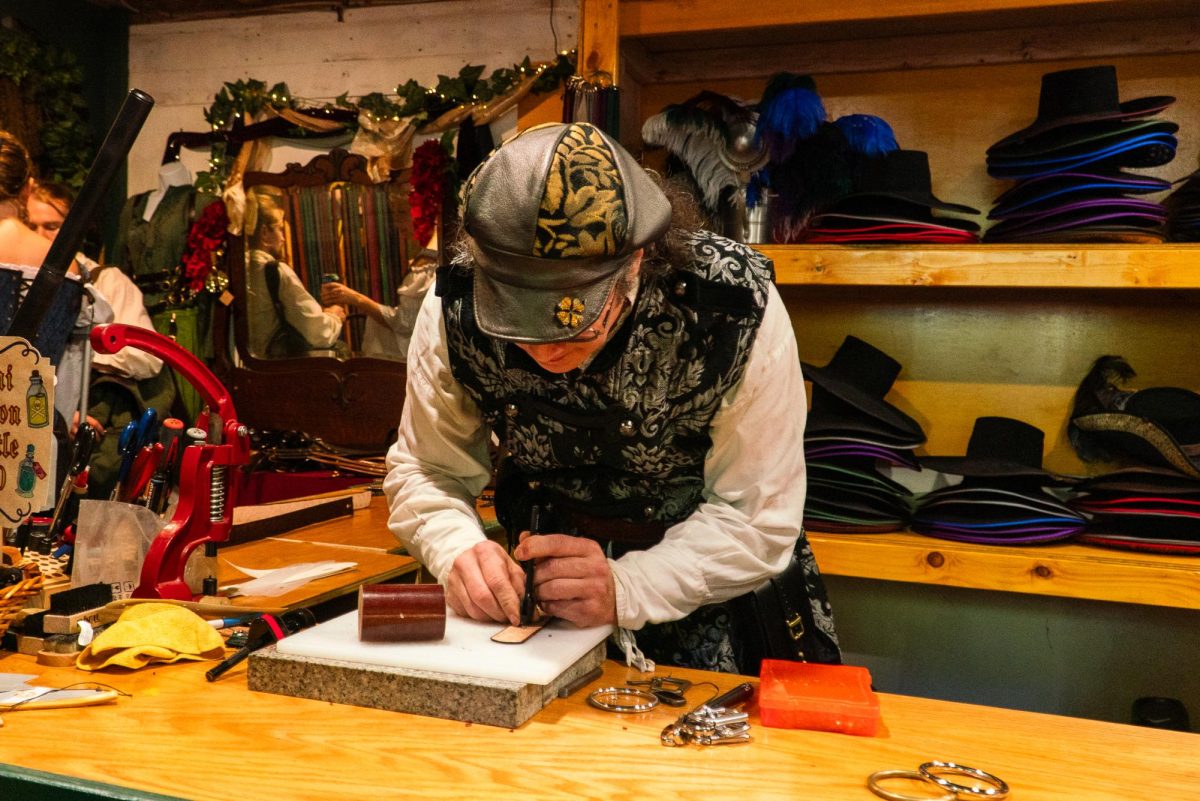 A skilled leather crafter demonstrates the process of making a bag. Vendors showcased their skills inside their shops and booths.