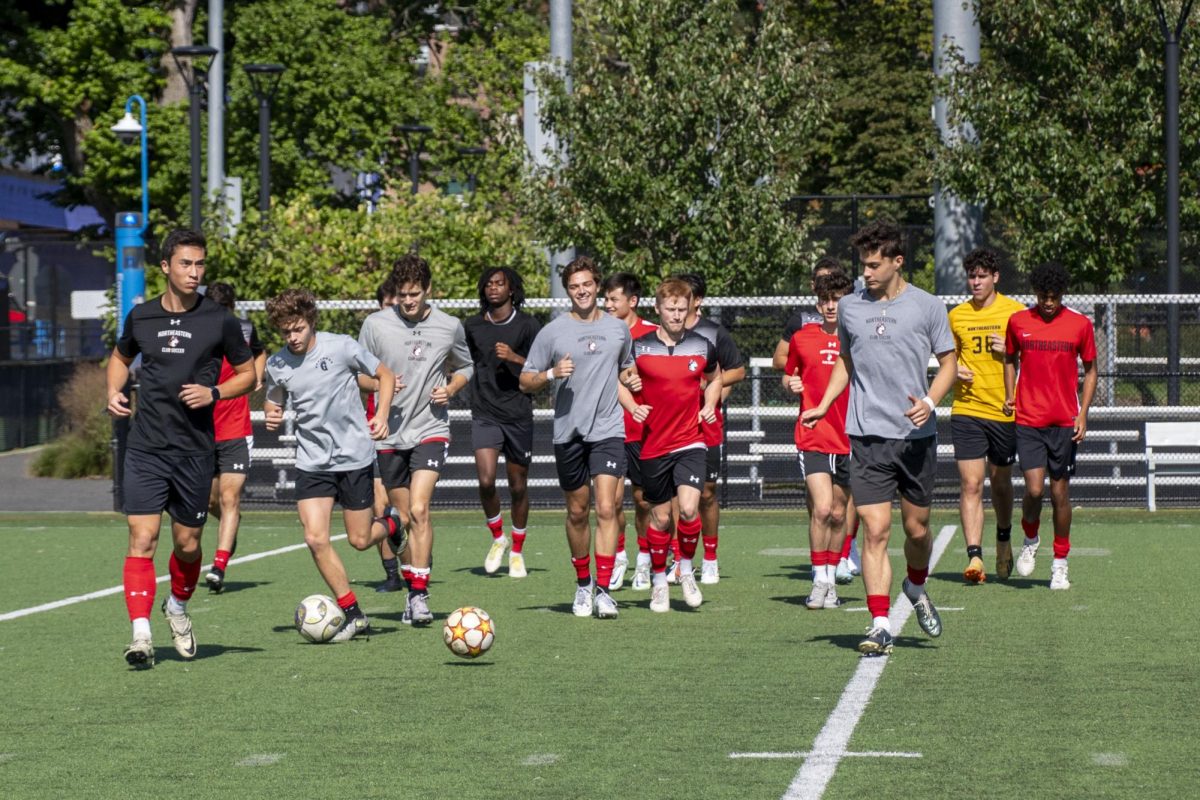 Members of the men's club soccer team run laps around Carter Field during a practice Sept. 28. The team's season started Sept. 4.