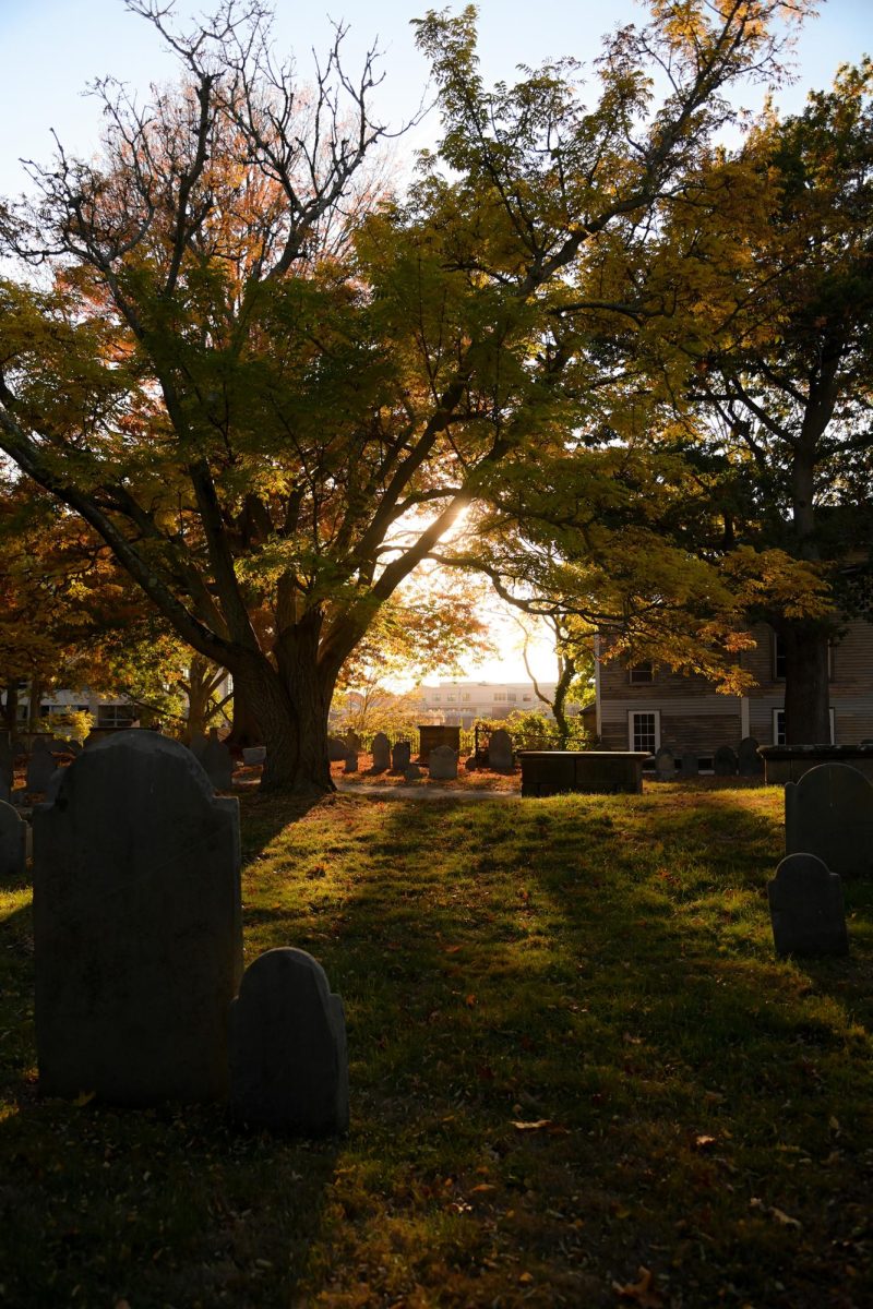 The sun casts light over Salem’s Old Burial Point of Charter Street Cemetery, home to old graves with a rich history serving as a backdrop to the Salem Witch Trials Memorial. Through walking and trolley tours, individuals could learn more about the history behind the origins of the trials.